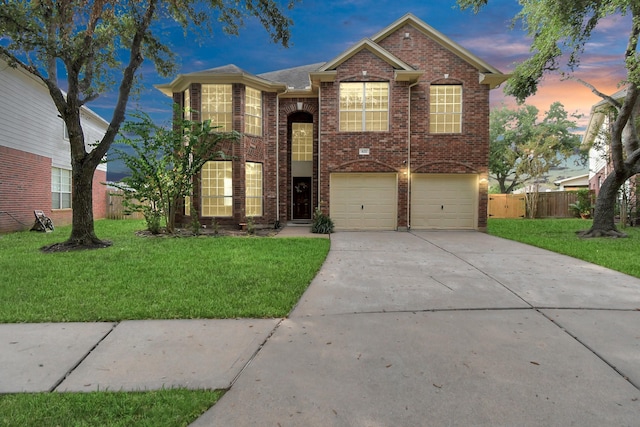 front of property with a lawn and a garage