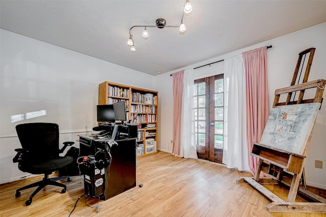 office space featuring french doors and light hardwood / wood-style floors