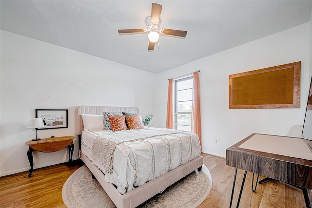 bedroom featuring ceiling fan and light hardwood / wood-style flooring