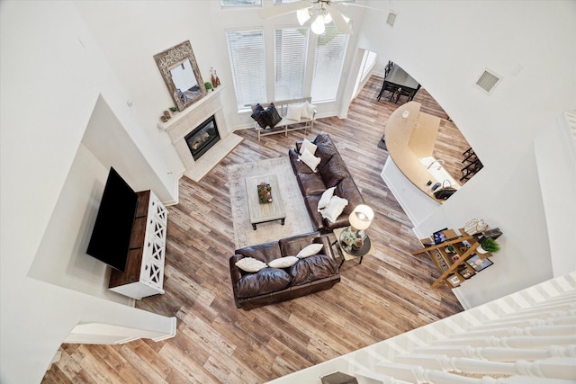 living room with hardwood / wood-style flooring and ceiling fan