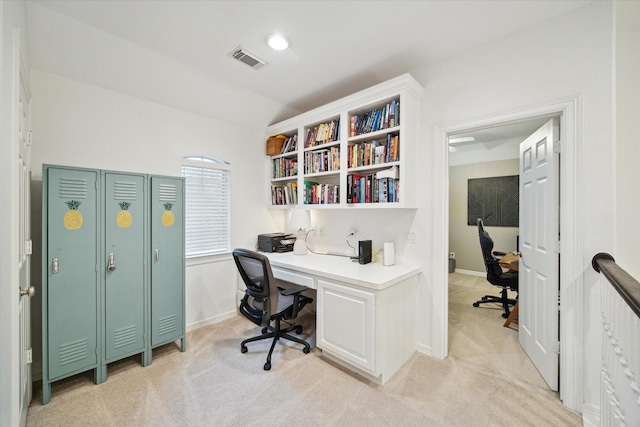 home office with light carpet and vaulted ceiling