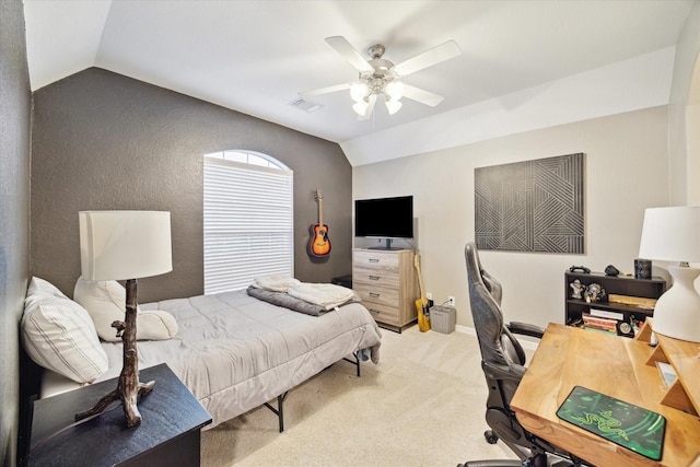 bedroom with ceiling fan, vaulted ceiling, and light carpet