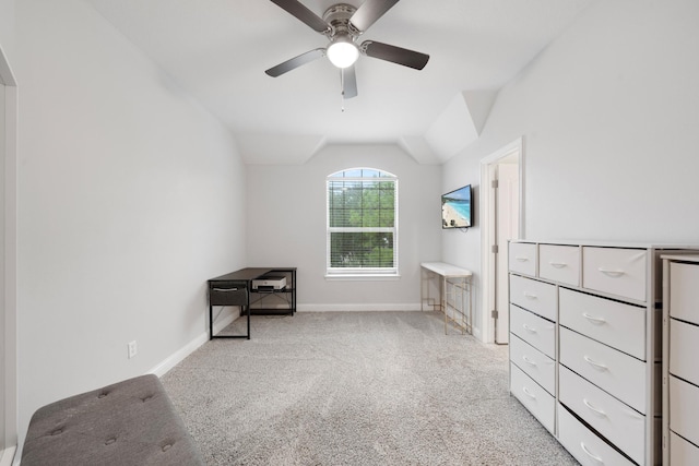 interior space with ceiling fan, light colored carpet, and vaulted ceiling