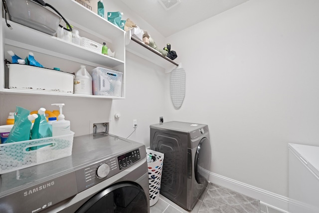 washroom with light tile patterned floors and independent washer and dryer