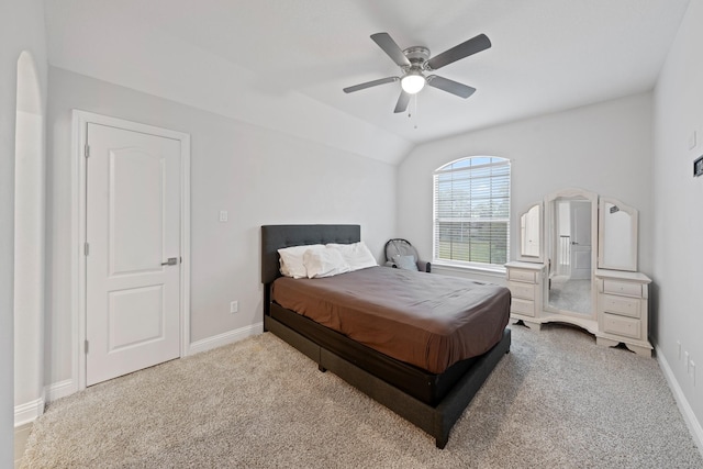 bedroom with ceiling fan, lofted ceiling, and light colored carpet