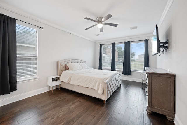 bedroom featuring ceiling fan, ornamental molding, and dark hardwood / wood-style flooring