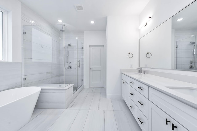 bathroom featuring vanity and plus walk in shower