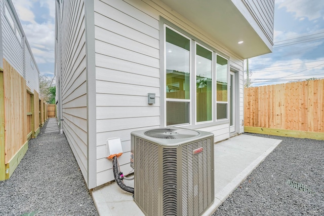 view of property exterior featuring cooling unit and a patio area