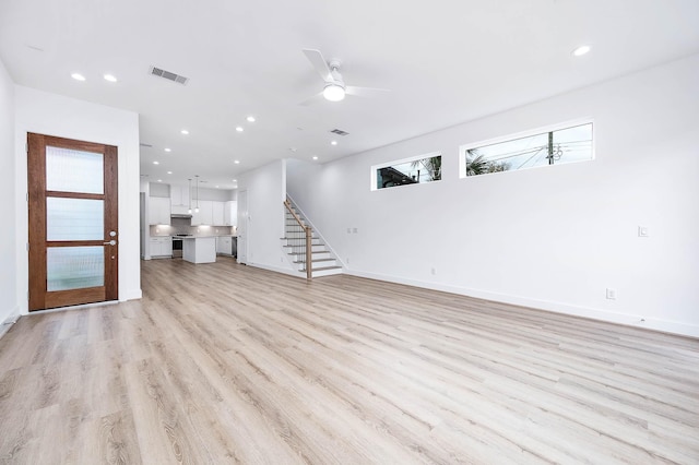 unfurnished living room featuring light hardwood / wood-style floors and ceiling fan