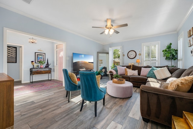 living room with ceiling fan, crown molding, and wood-type flooring