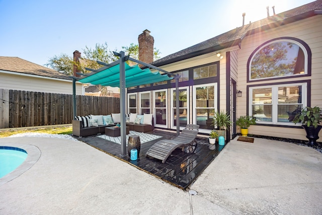 rear view of house featuring a patio area and an outdoor living space