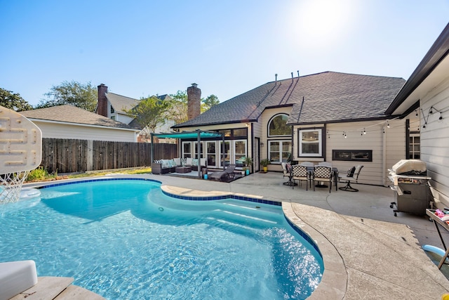 view of swimming pool featuring an outdoor hangout area, a patio, and a grill