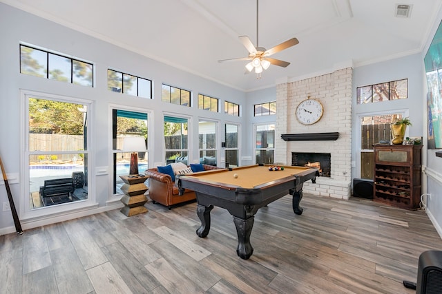 playroom featuring ornamental molding, a wealth of natural light, and wood-type flooring