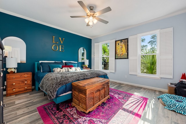 bedroom with ornamental molding, ceiling fan, and hardwood / wood-style floors