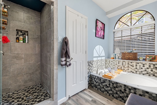 bathroom with hardwood / wood-style floors and separate shower and tub