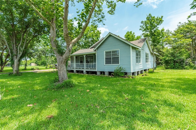 back of property featuring a yard and a porch