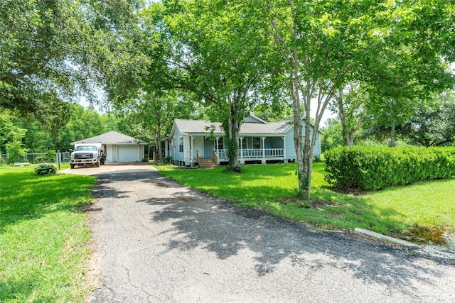 view of front facade featuring a porch, a front yard, and a garage