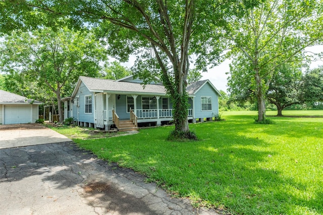 view of front of home featuring a front yard, covered porch, and a garage