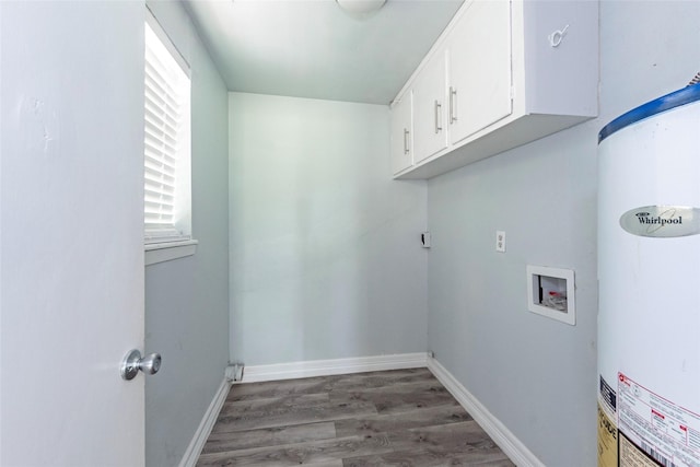 clothes washing area featuring cabinets, hookup for a washing machine, light wood-type flooring, and gas water heater