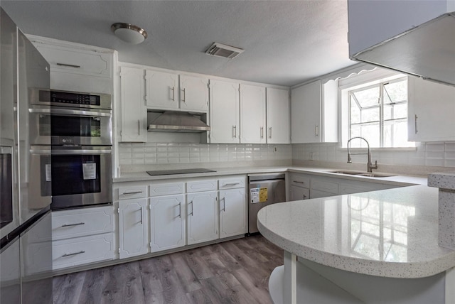 kitchen with white cabinets, appliances with stainless steel finishes, and sink