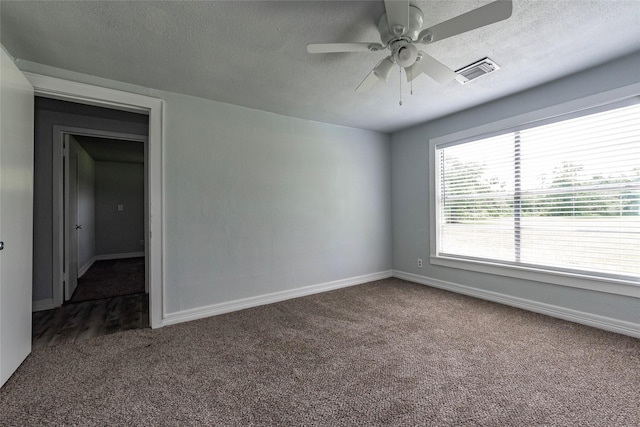 spare room featuring ceiling fan, carpet floors, and a textured ceiling