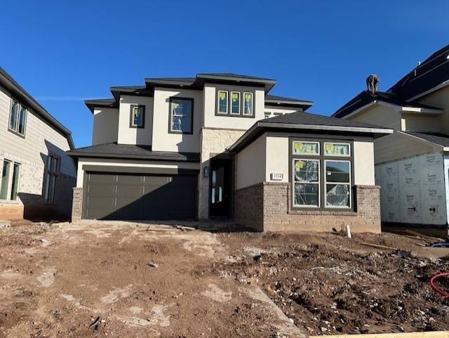 prairie-style home featuring a garage