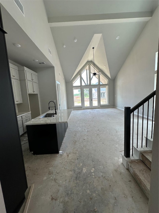 living room featuring visible vents, ceiling fan, stairway, and lofted ceiling