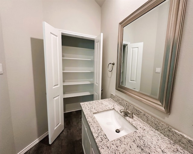 bathroom with hardwood / wood-style floors and vanity