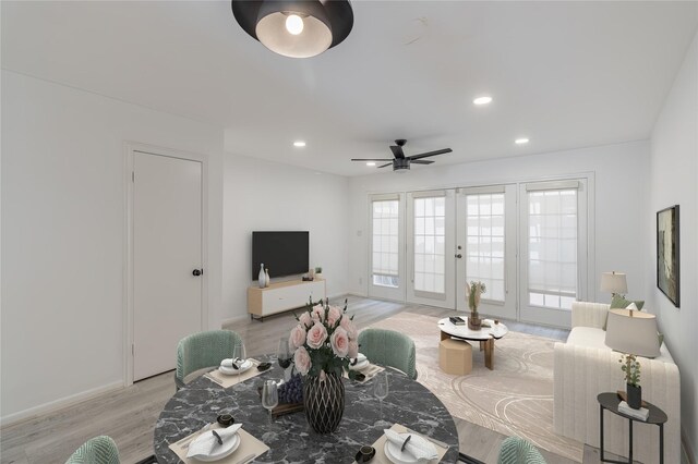 living room with french doors, ceiling fan, and light hardwood / wood-style flooring