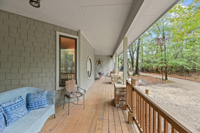 wooden deck featuring outdoor lounge area and a porch