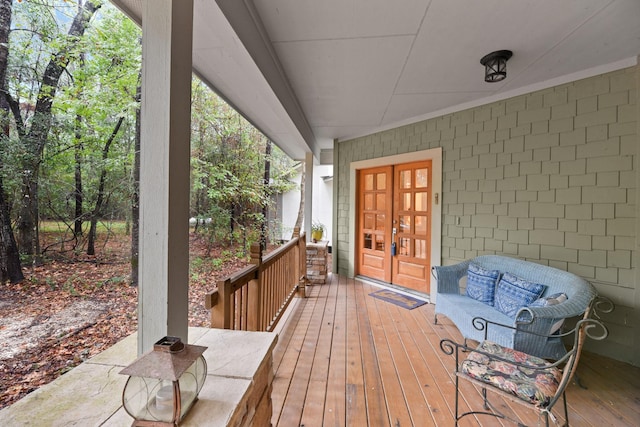 wooden deck with french doors and outdoor lounge area