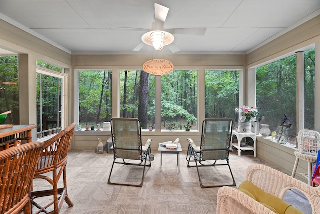 sunroom / solarium featuring ceiling fan