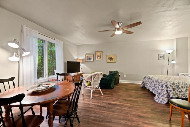 dining area featuring dark hardwood / wood-style flooring and ceiling fan