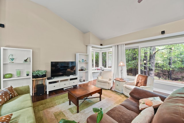 living room featuring a wealth of natural light, vaulted ceiling, and light hardwood / wood-style floors