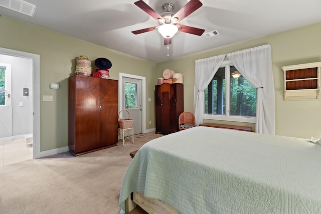 carpeted bedroom featuring a ceiling fan, baseboards, and visible vents