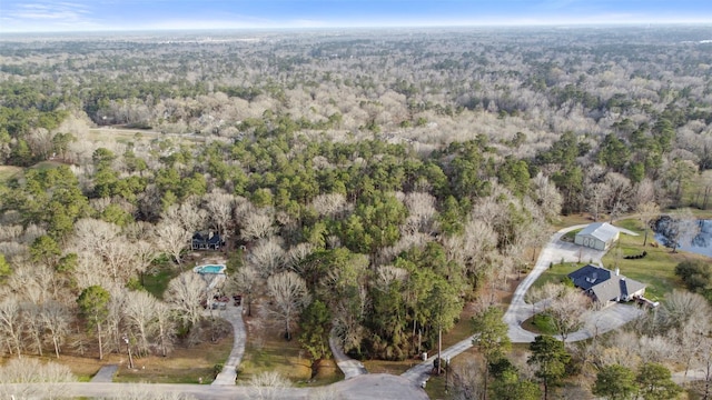 drone / aerial view featuring a wooded view