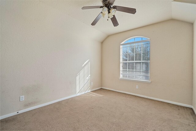 spare room with carpet floors, lofted ceiling, and ceiling fan