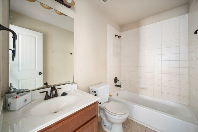 full bathroom featuring toilet, tile patterned floors, tiled shower / bath, and vanity