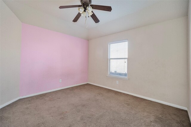 carpeted spare room with ceiling fan and lofted ceiling