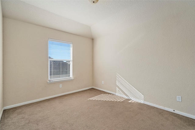 unfurnished room featuring carpet flooring and baseboards