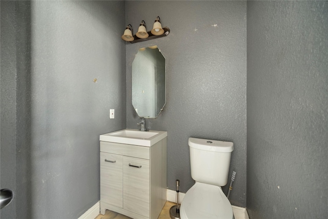 bathroom with toilet and vanity