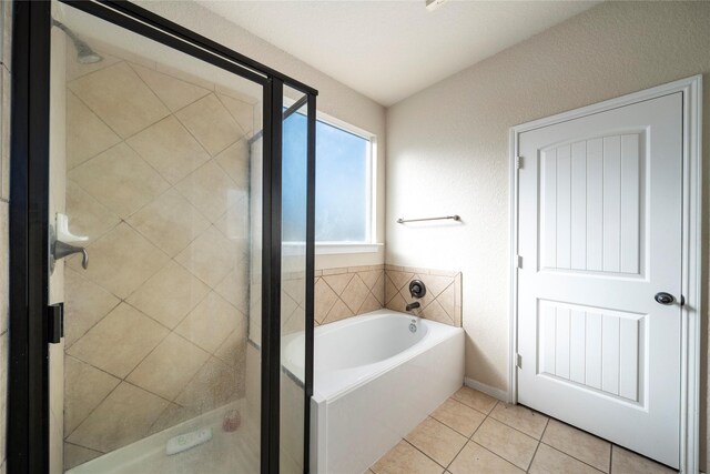 bathroom with independent shower and bath and tile patterned floors