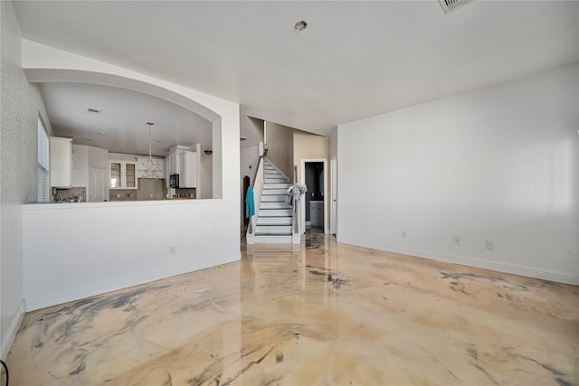 14202 Merganser Dr, Houston, TX 77047 - unfurnished living room featuring stairs, baseboards, and concrete floors