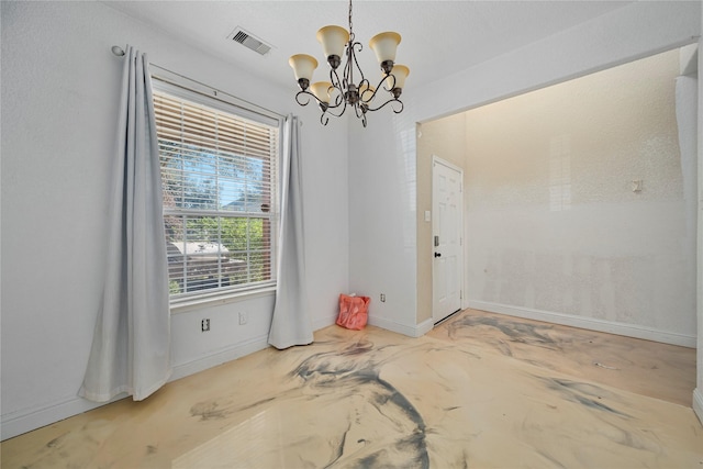 spare room featuring an inviting chandelier