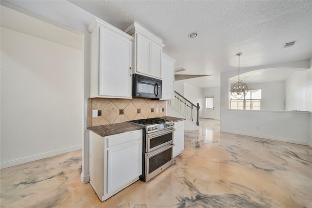 kitchen featuring double oven range, decorative backsplash, white cabinets, and pendant lighting