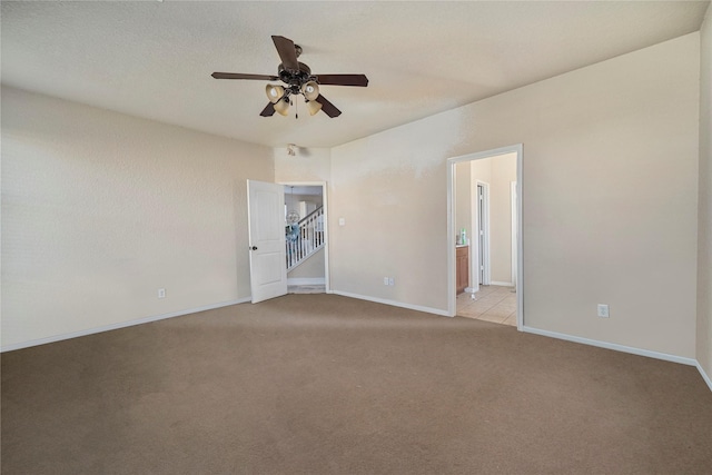 carpeted empty room with ceiling fan