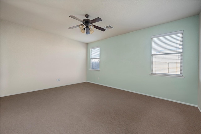 empty room with ceiling fan and carpet floors