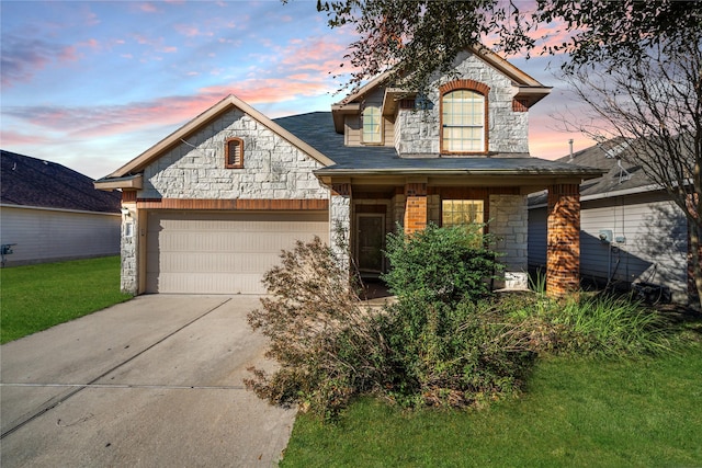 view of front of house featuring a garage and a lawn