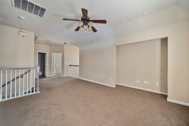 unfurnished room featuring a textured ceiling, ceiling fan, carpet, and lofted ceiling