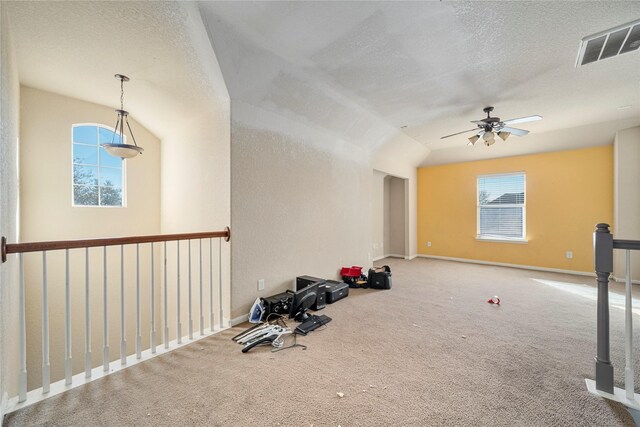 interior space with visible vents, a textured ceiling, ceiling fan, and baseboards